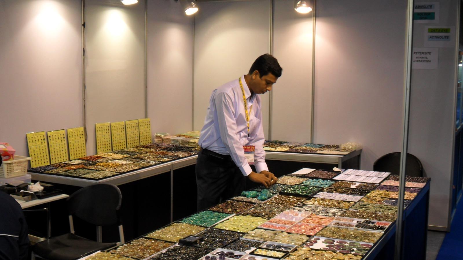 A Shree Petch & Ploy team member arranging gemstone trays