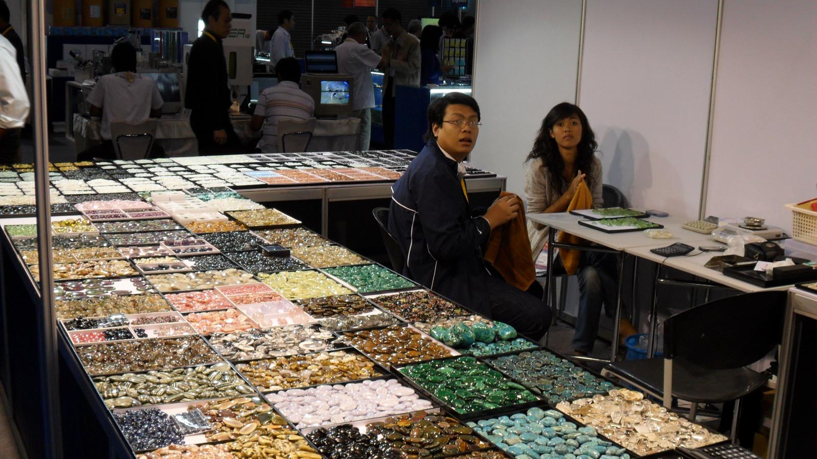 Trays of gemstone cabochons on display at the Shree Petch & Ploy booth